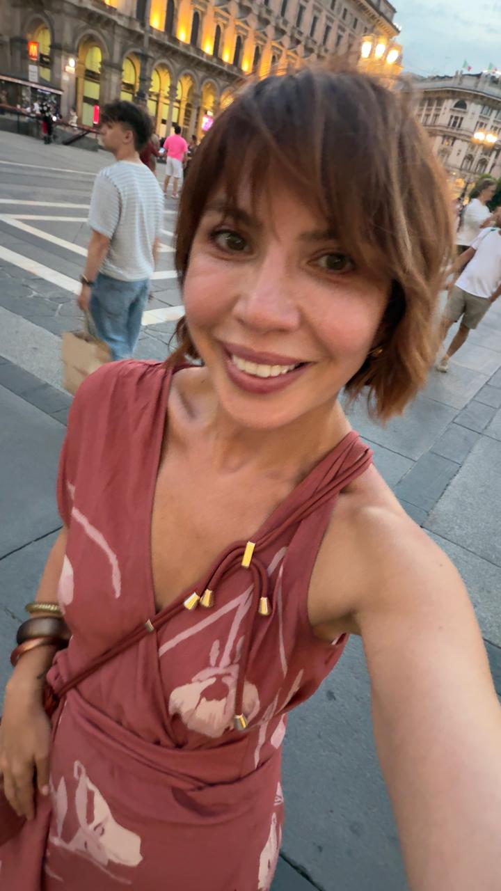 Evening portrait in a rose printed dress on a Milan piazza